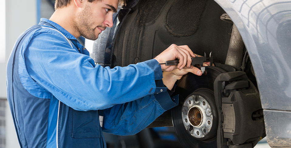 Mechanic fitting new brake pads - Brakes Horndean